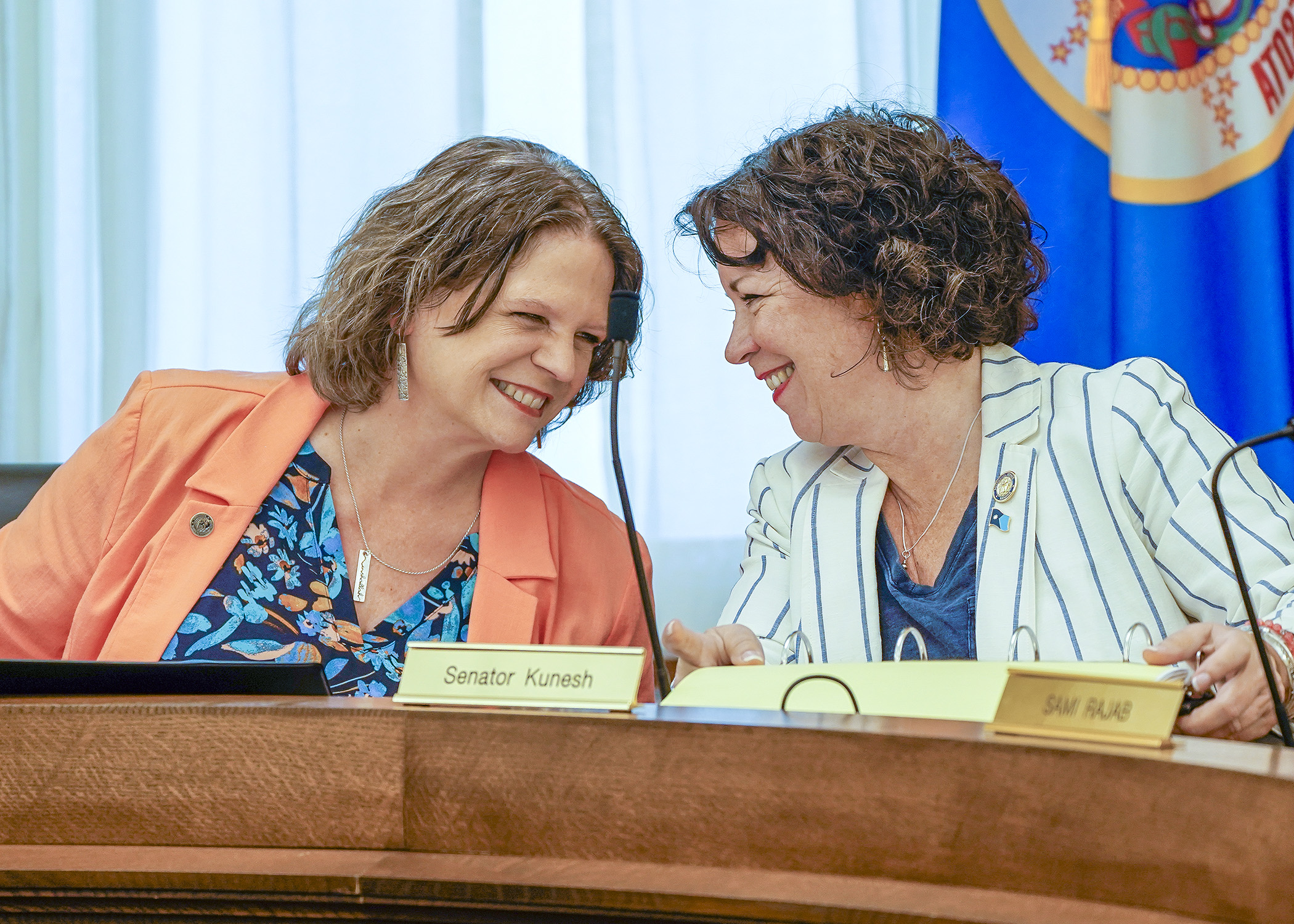 Rep. Cheryl Youakim and Sen. Mary Kunesh confer before gaveling in the May 10 meeting of the education supplemental budget bill conference committee. (Photo by Andrew VonBank)